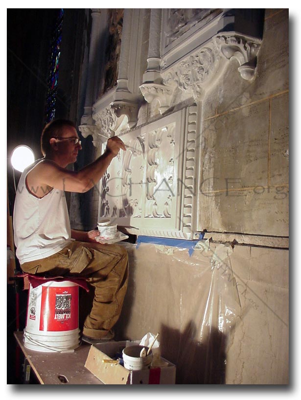Artisian restoring the plaster walls